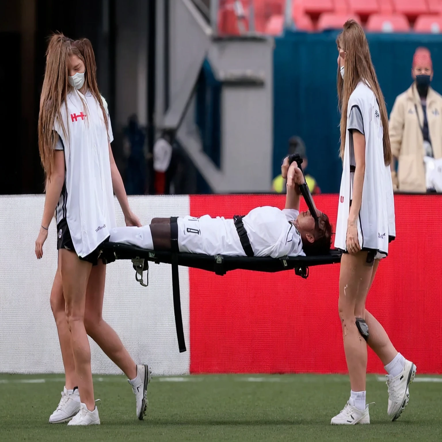 a soccer scene in a sports stadium, cool and wet weather conditions, humide ground, rainy sky, injury scene in a sports stadium, stretcher carry, there are four female medics carrying a stretcher, there are four female medics in very shiny coats who are carrying a stretcher in a sports stadium, there is a wounded male soccer player in a matte short cotton sports outfit lying on the stretcher, an injured male soccer player in matte cotton sportswear is lying in pain on a stretcher, a soccer player in matte cotton sports clothes is rearing up in intense pain while lying on a stretcher, dramatic scene, theatralic posing scene, dramatic pity scene, injury soccer, first aid, help, pity, there are four female medics in wetlook high-shine coats who are looking very sad and very terrified and very shocked, the injured soccer player is screaming out in pain while he is carried from the pitch on a stretcher