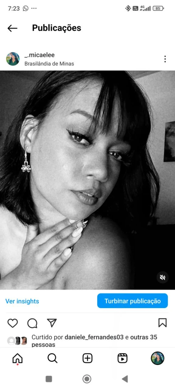 Dark-skinned woman with straight, short hair and professional bangs in braids