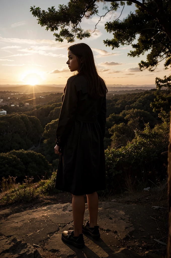 A young woman stands on a cliff. Waiting for someone, backlit image, silhouette
