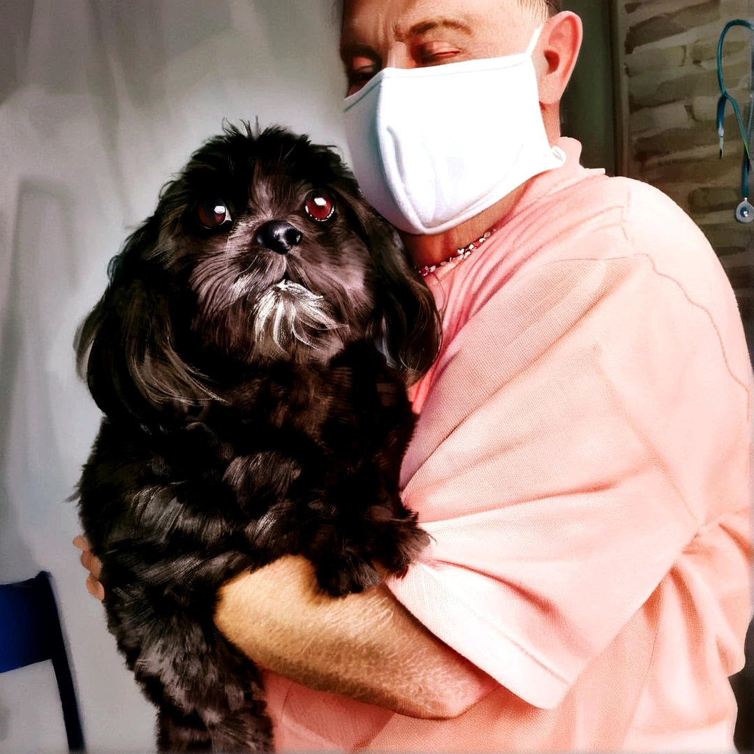A little dog with black fur, floppy ears on the lap of a man with a mask, disney pixar style, high qualiy, best qualityer.