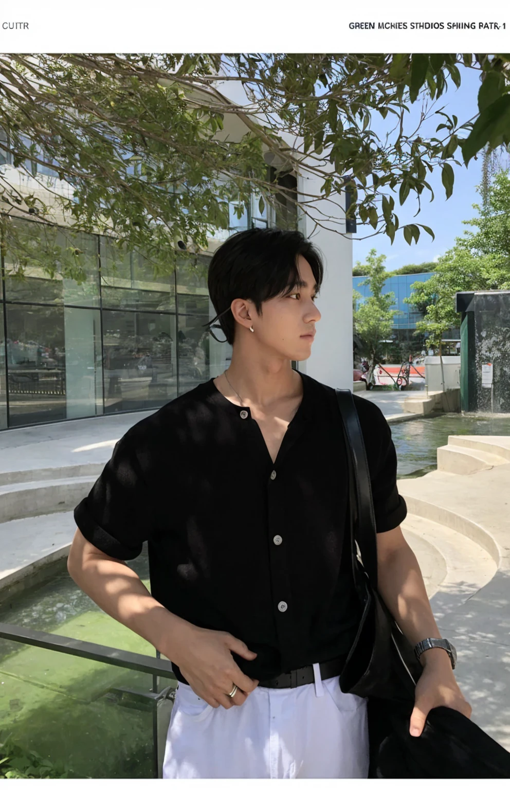 Portrait of a stylish young man with a cafe in the background。He was wearing a grey short-sleeved T-shirt and black pants.、It has a simple and modern style。His hair is neatly black.。His expression is serious、Facing to the side。A fashionable streetscape in the background。I feel class in the silver necklace.。He has a black jacket in his hands。The contrast of light and shadow makes his outline stand out.。
