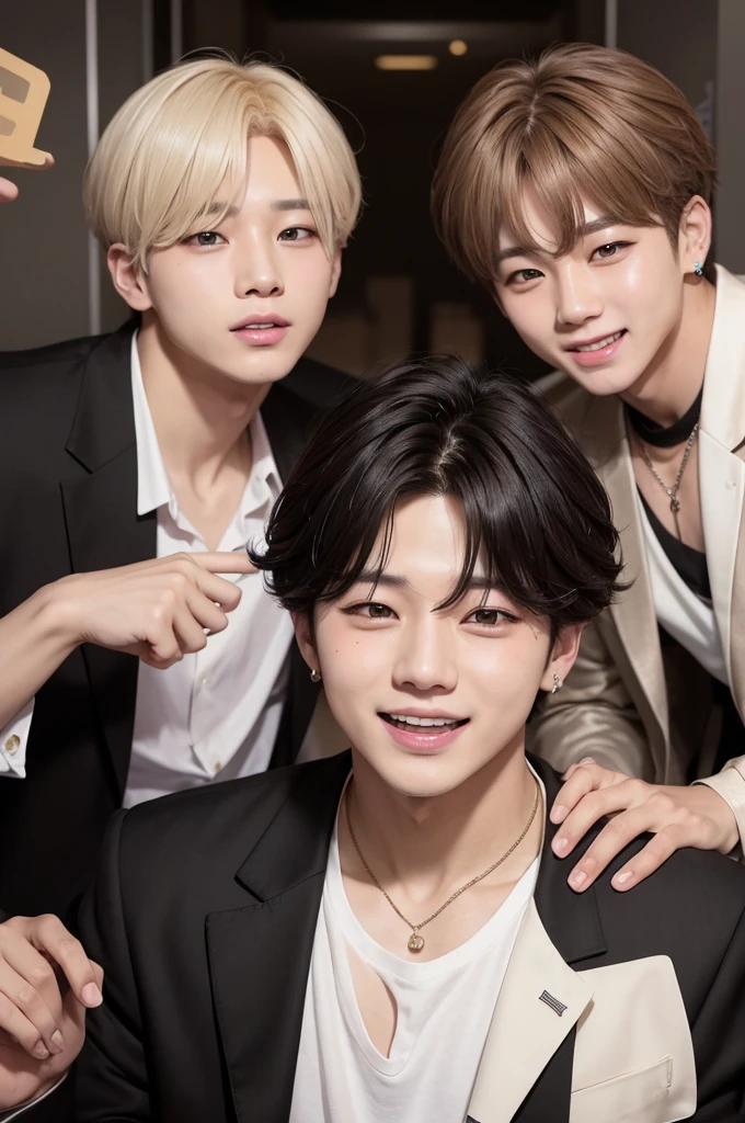 Jungkook, Jimin, and Taeyoung from BTS in a company do Jimin with blonde hair right in front of the camera and very close serious and thoughtful and Jungkook with black hair laughing at Taeyoung with brown hair the two in the background of the photo.