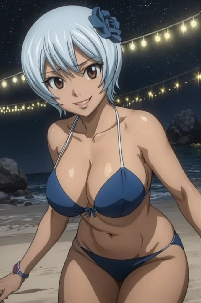 Yukino Aguria, a dark-skinned woman wearing a bikini smiling on the beach at night 