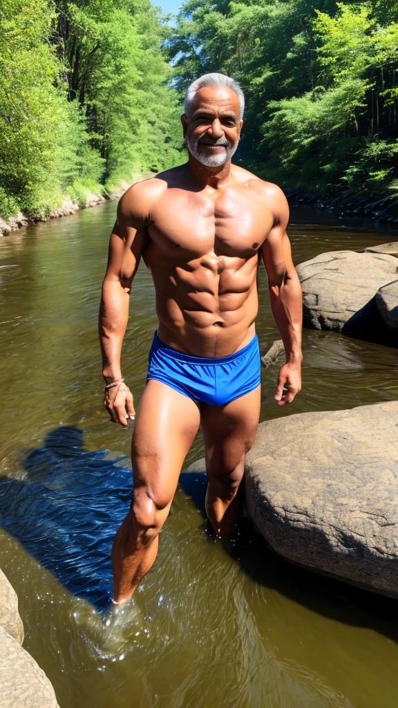 Man with an athletic body of about 55 years old in a river