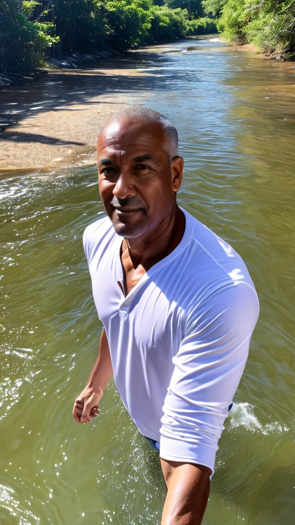 Man with an athletic body of about 55 years old in a river, with white shirt