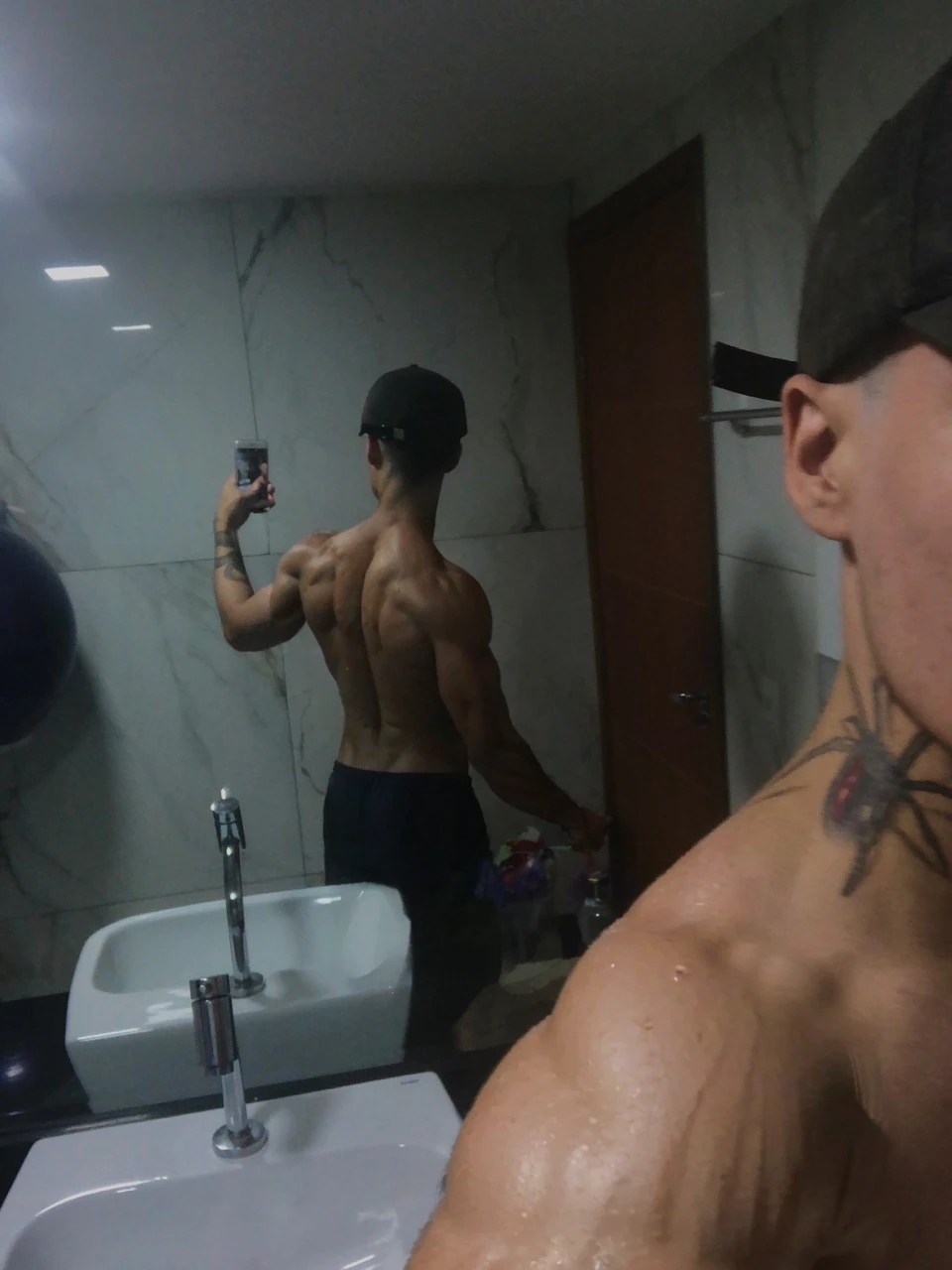 a muscular man with defined abs taking a selfie, wet skin, hot and strong, (best quality,4k,8k,highres,masterpiece:1.2),ultra-detailed,(realistic,photorealistic,photo-realistic:1.37),intricate details, cinematic lighting, dramatic shadows, wet skin, toned body, muscular build, handsome face, intense expression, outdoor setting, summer day