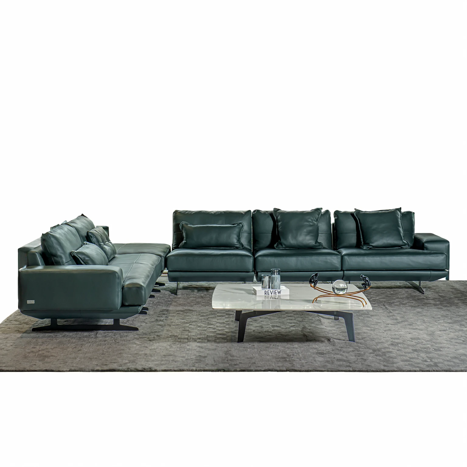 Design a luxurious and modern living room with high ceilings and a sophisticated aesthetic. The room features a large sectional sofa with a mix of neutral and dark pillows, a stylish round coffee table, and a sleek entertainment center with built-in shelving. The space is illuminated by elegant circular pendant lights hanging from the ceiling. Large floor-to-ceiling windows allow natural light to flood the room, highlighting the contemporary decor and creating an inviting atmosphere. Add a few decorative items and books on the shelves to enhance the sophisticated feel.
