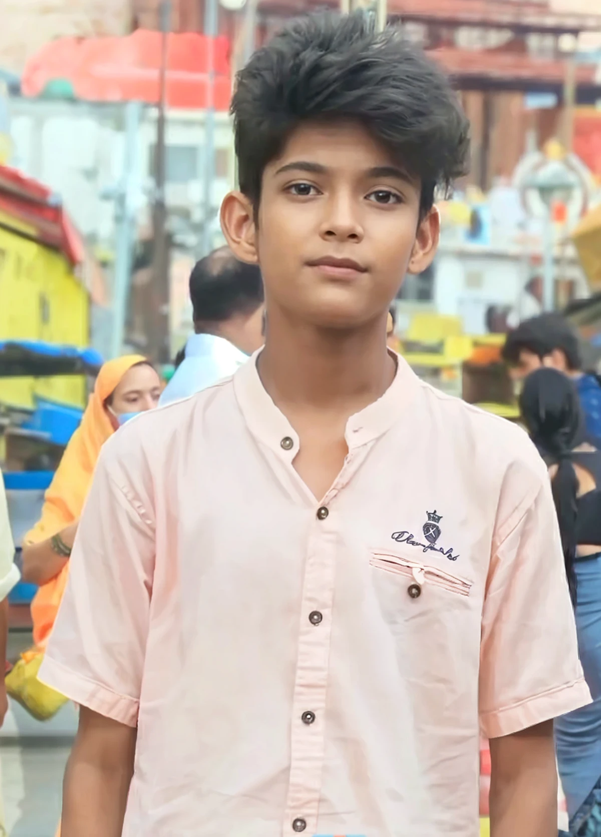 A boy sitt on old green color car with green baloons , little normal beared, lens background blur, boy wearing green coat
