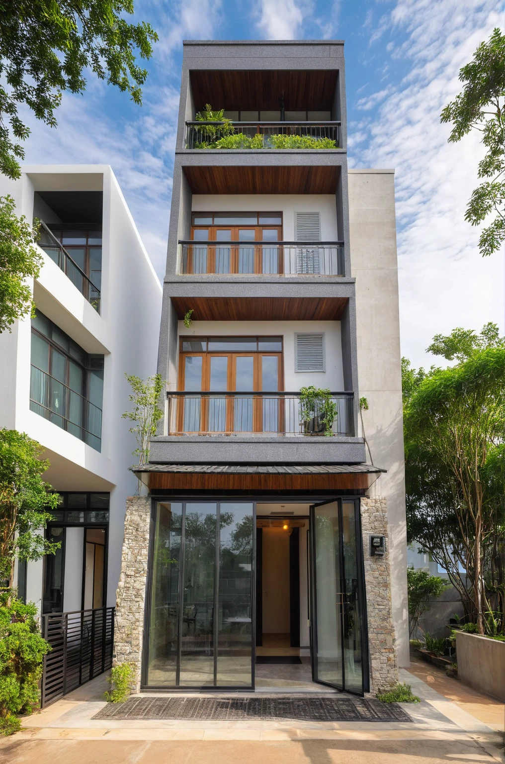 A 2-story house in Da Lat, captured in crisp morning light. This contemporary abode showcases a mix of contemporary dark granite, whitewash, expansive glass, concrete and wood accents, surrounded by greenery and stone details. Crafted by Vo Trong Nghia, the house exudes a peaceful and elegant space, perfectly suited to its landscape location.