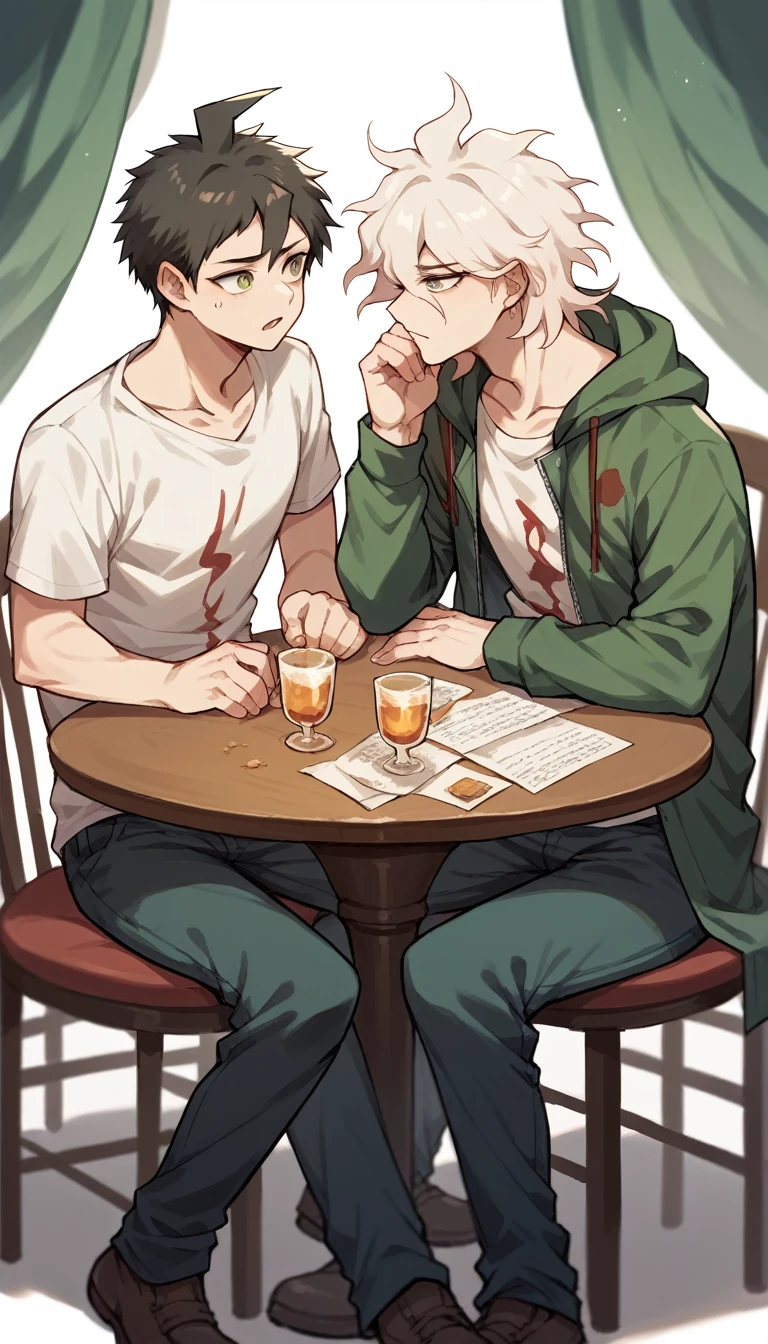 Two guys sitting at a table and talking