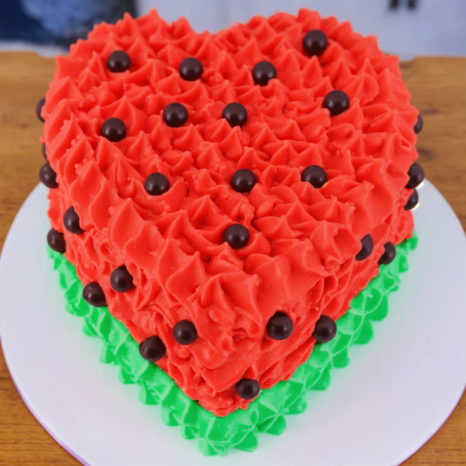 on a wooden table, red and green cream heart cake, star shaped cream, with black plastic beads, Multiple light sources, bright lighting, Realistic style , realistic texture, detailed texture, A high resolution, high quality,