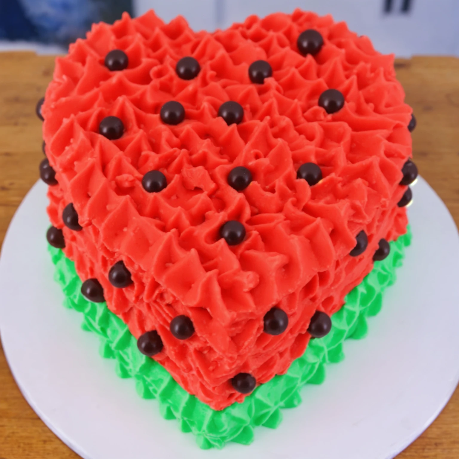on a wooden table, red and green cream heart cake, star shaped cream, with black plastic beads, Multiple light sources, bright lighting, Realistic style , realistic texture, detailed texture, A high resolution, high quality,