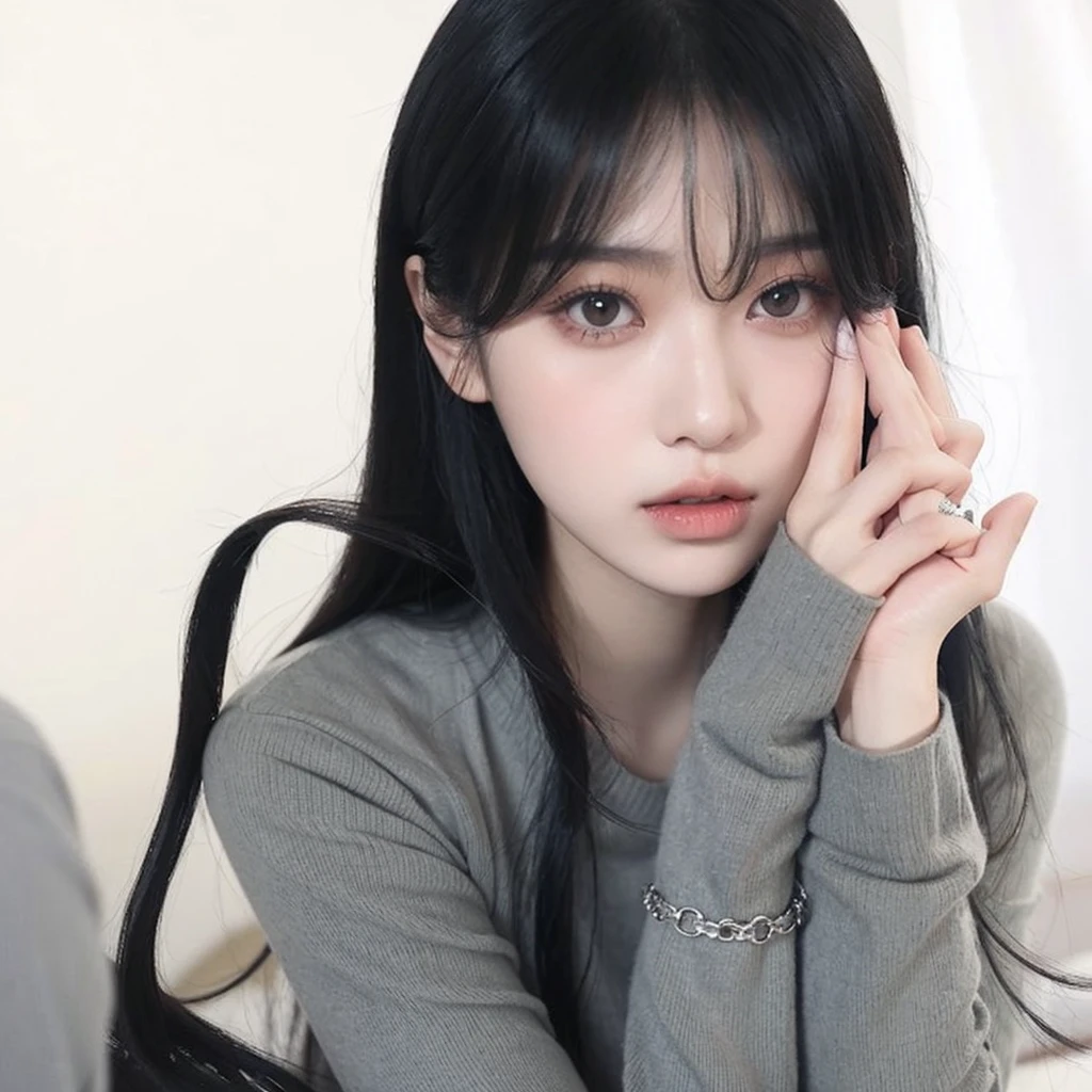 Korean girl with long black hair, straight and with bangs. Ulzzang girl with gothic style and soft face. He has black hair with bangs and pale skin.. She wears a gray blouse.She has both hands next to her cheek.. 