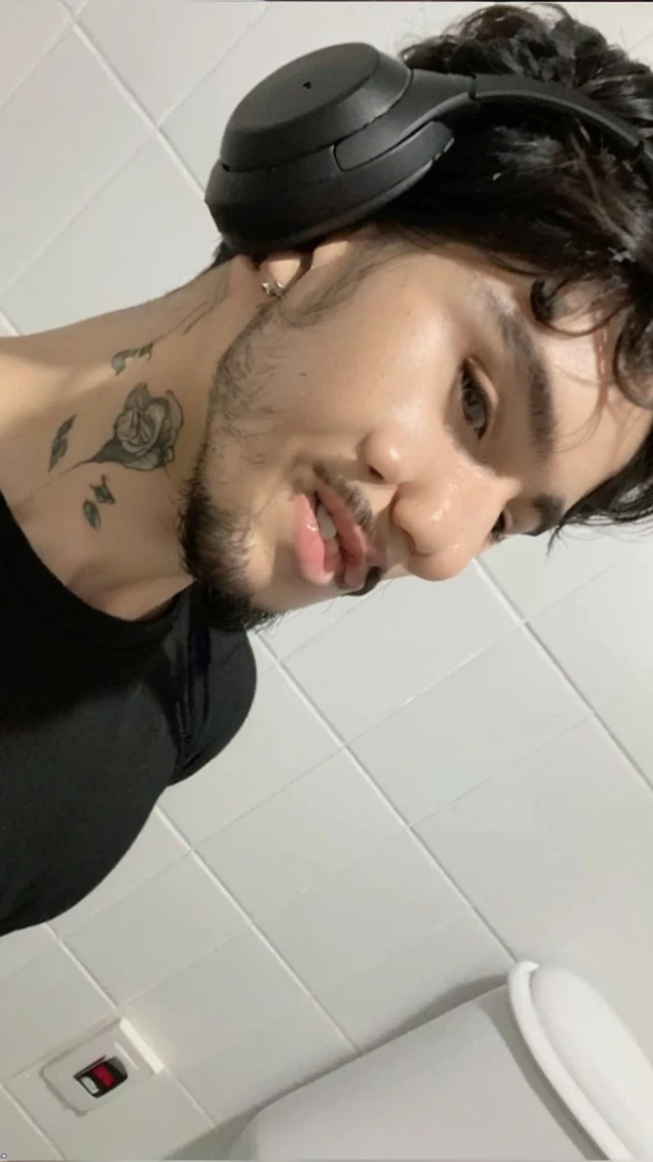 a smiling man with black hair wearing headphones, beautiful detailed eyes, beautiful detailed lips, extremely detailed face, longeyelashes, detailed facial features, closeup portrait, cinematic lighting, warm color tones, photorealistic, (best quality,4k,8k,highres,masterpiece:1.2),ultra-detailed,(realistic,photorealistic,photo-realistic:1.37),HDR,studio lighting,sharp focus,vivid colors,professional portrait