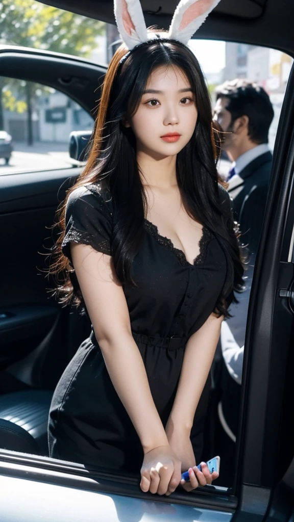 Draw a picture of a rather plump young Asian woman with long, wavy, dark brown hair. She wore a Bunny Ears Headband and a black blouse that revealed a bit of cleavage. This woman was standing next to the car with the door closed but the car window open, looking down slightly with one hand leaning on the door and the other holding her cell phone. The angle of this photo is from inside the car, showing the view from the side of the car door towards the woman. The background is nighttime with dim lighting, and there is some graffiti or murals on the wall behind the woman.