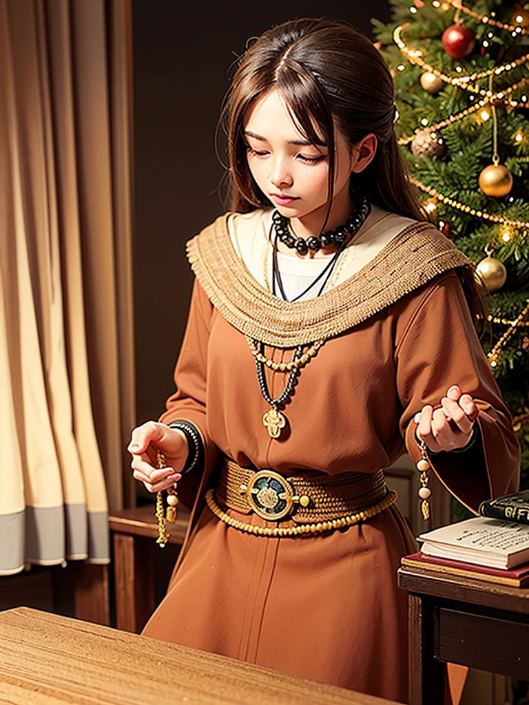 a prayer beads cord of brown beads with metalic medal carved with a tree, on a table, over a open book, focus in the medal