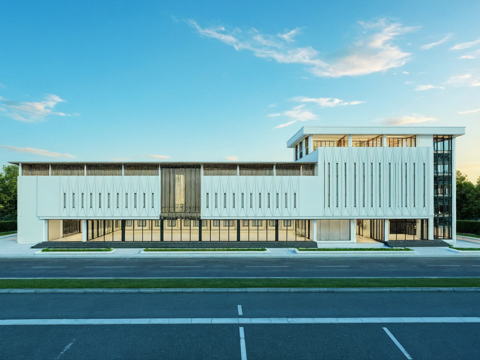Masterpiece, high quality, best quality, authentic, super detail, outdoors, wedding center style neoclassic, city landscape, white wall, glass windows, gate road, pavement, grass, trees, blue sky, sunset, cloud, (day:1.1), realistic lighting