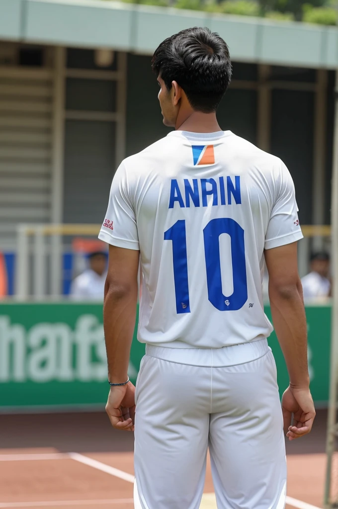 An asian man standing ,wearing indian cricket team tshirt with name AYAAN and number 7 on his backside of thsirt and holding cricket wicket keeping gloves