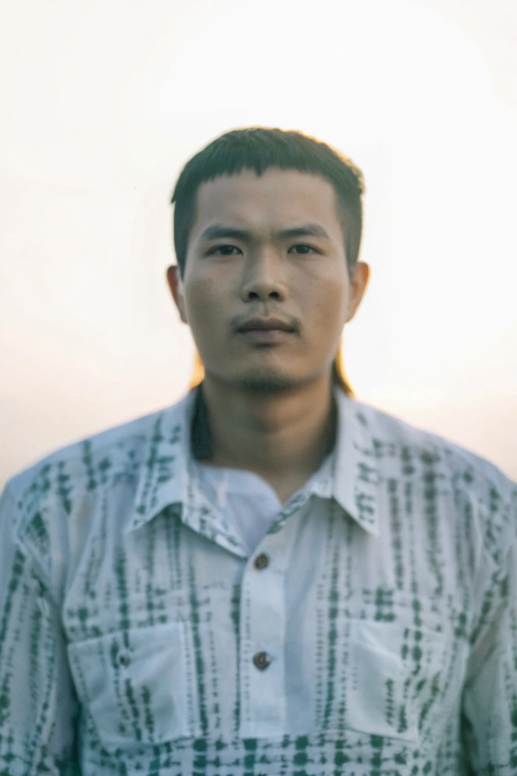 Highly realistic photo, Portrait of a 25 year old Vietnamese young boy, green shirt