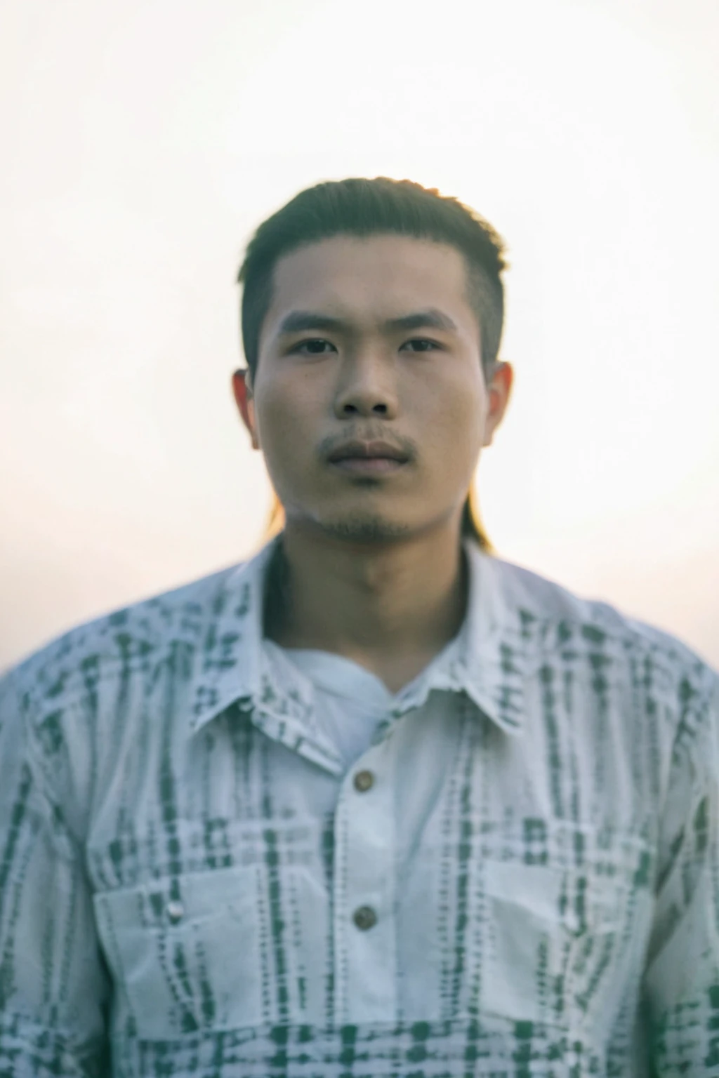 Highly realistic photo, Portrait of a 25 year old Vietnamese young boy, green shirt