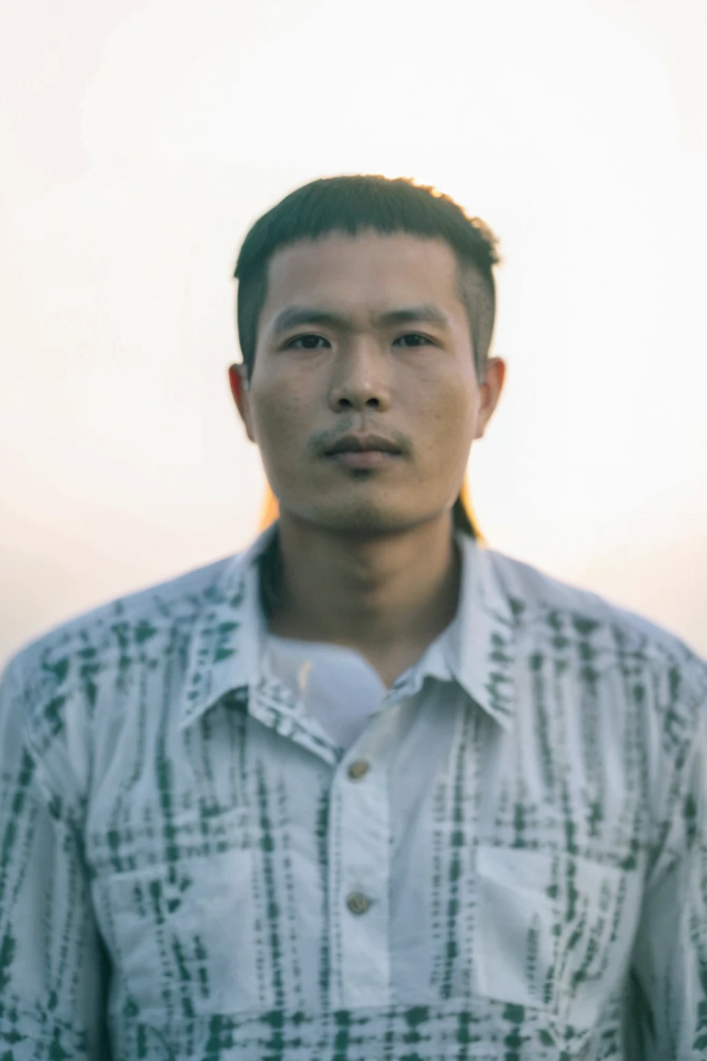 Highly realistic photo, Portrait of a 35 year old Vietnamese young boy, green shirt