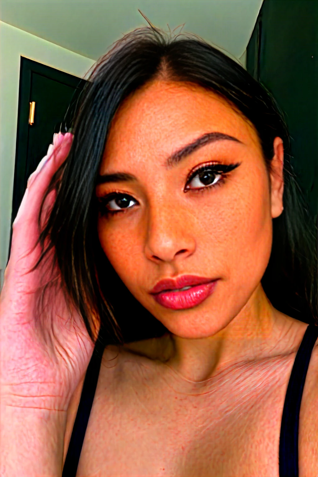 A young 19-year-old woman named Lila Nakamura with a mixed Japanese and Northern European heritage. She has thick dark black eyeliner, glossy lips, and a cute, endearing expression. She has straight, black hair with blonde highlights or a blonde tint that falls just past her shoulders, styled in a neat and polished manner. Her eyes are almond-shaped with a light, striking blue color, accentuated by subtle eyeshadow and mascara. Her skin has a light tone with a natural, fresh look, and she has a few delicate freckles across her nose. Nude, in the bedroom