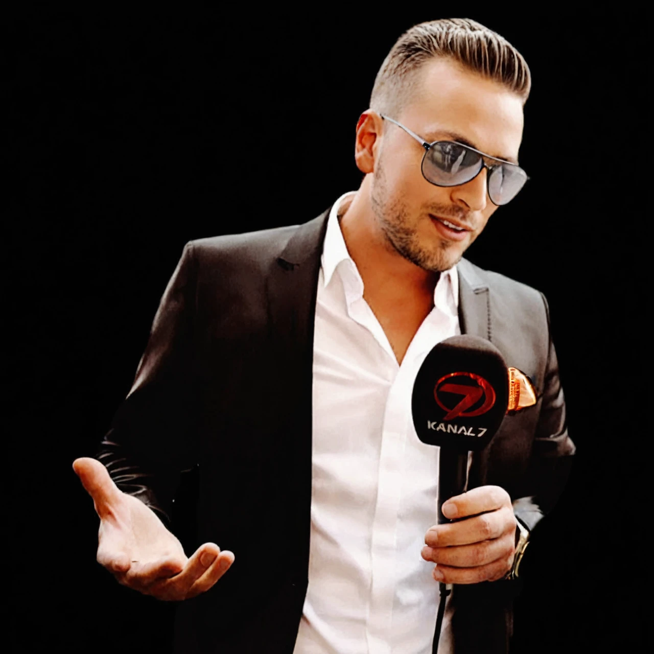 a young, handsome man who has not aged a day, giving a futuristic interview in a sleek, high-tech setting, wearing a fashionable outfit