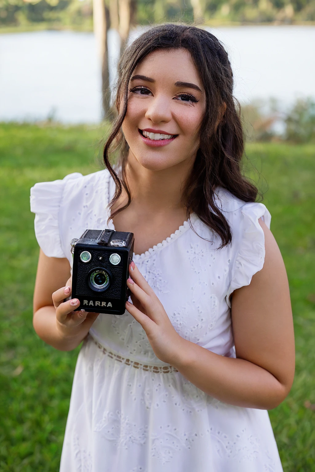 create a Disney pixar character. She is a photographer, in white dress, holding the camera with your hands, nature background.