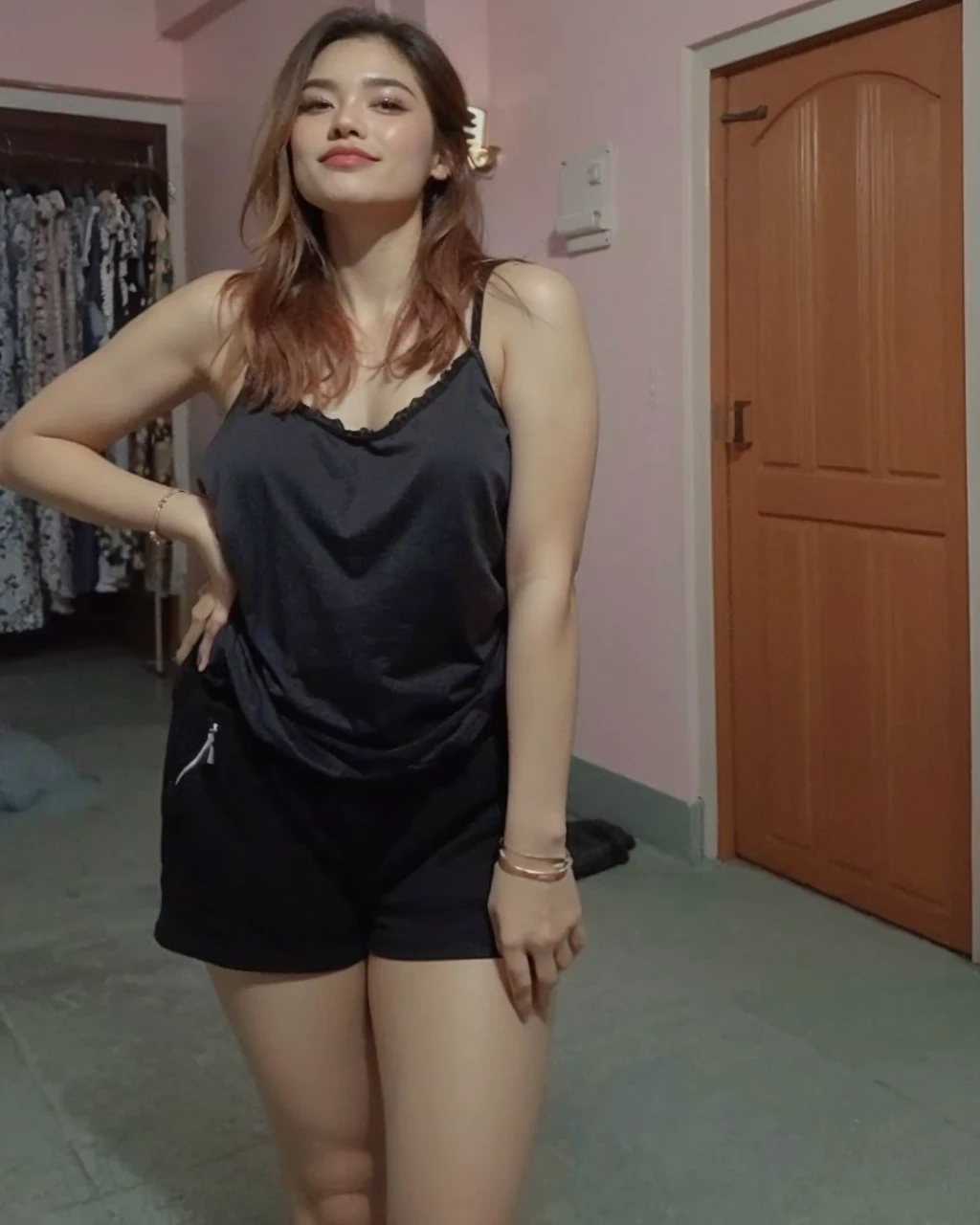 A beautiful woman standing in a room with a hair brush, wearing a camisole and tight shorts, she is wearing a black tight tank top, in tight shorts, posing in a bedroom, sexy pose, satisfied pose, wearing black shorts, tight black tank top and shorts, wearing black camisole outfit, sexy look, wearing a tank top and shorts, very sexy pose