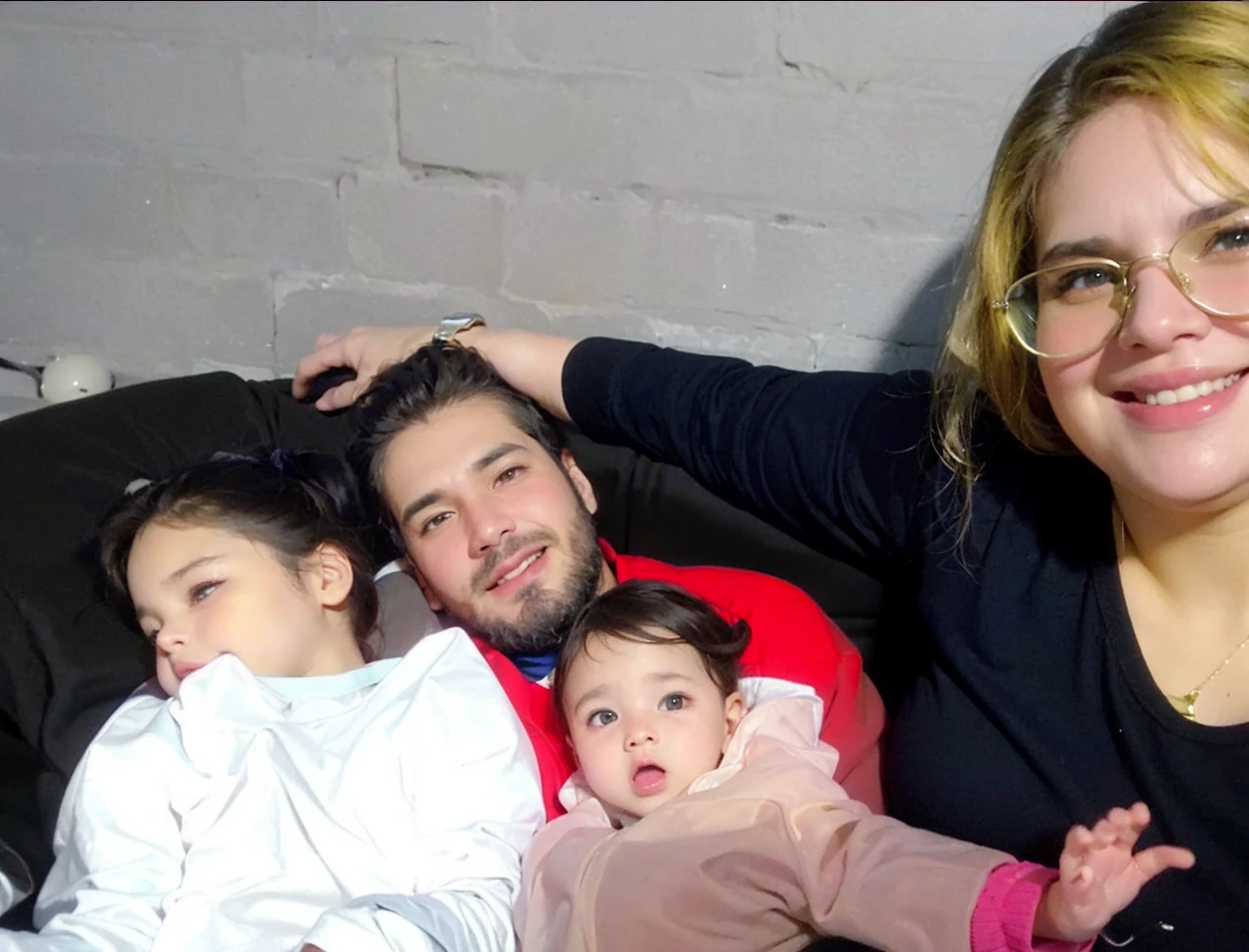 I want a cell phone wallpaper photo that is of a family of 4 , with the following descriptions: a tall chubby woman with chocolate hair color copper green eyes, tall thin man black hair with beard brown eyes, 9 month old girl brown hair brown eyes and 4 year old boy brown hair brown eyes.
all together hugged