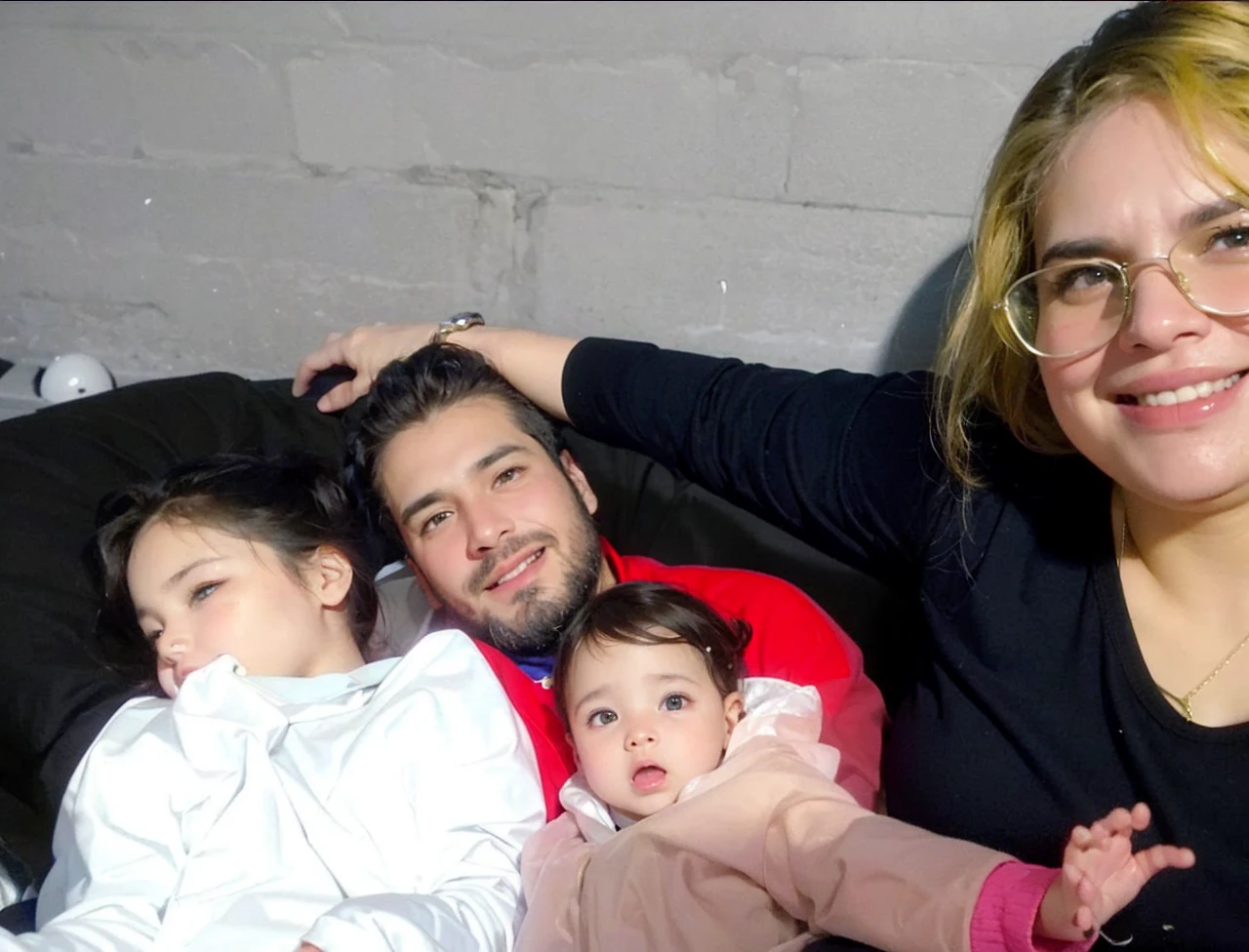 I want a cell phone wallpaper photo that is of a family of 4 , with the following descriptions: a tall chubby woman with chocolate hair color copper green eyes, tall thin man black hair with beard brown eyes, 9 month old girl brown hair brown eyes and 4 year old boy brown hair brown eyes.
all together hugged
