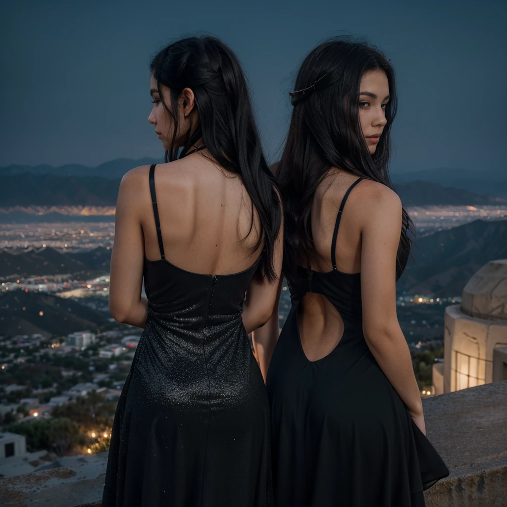 a girl with messy long black hair facing his back wearing a black elegant dress with glitter on top of the mountain overlooking los angeles at dark night
