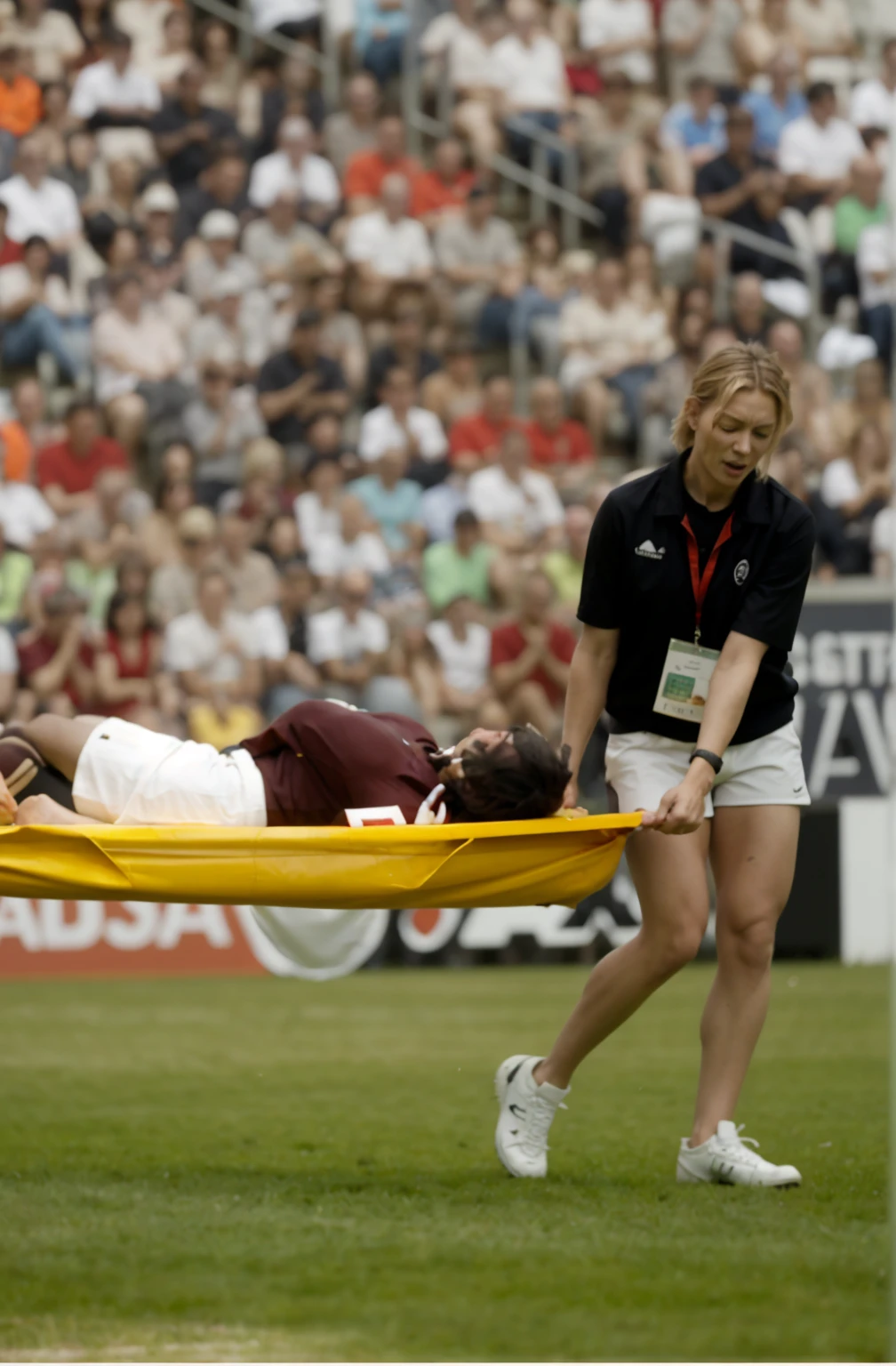 a blond woman is carrying a astretcher on a soccer field, there is a male soccer player in short sportswear lying injured on a stretcher, there is an injured sportsman who is covering his face on a stretcher, an injured sportsman is covering his face with his hands, an injured sportsman is writhing ecstatic in pain on a stretcher, dramatic pity pose, there is a very female woman in a high-shine coat, a high-shine black wetlook coat, a long shiny coat, a wetlook glossy coat, a wet black laquered coat, a very female looking wife is wearing a wetlook coat, injured, medic, soccer action pose, affection pose, ????????? action pose, dramatic action pose, theatralic pose, there is an attractive woman that is carrying a suffering man on a stretcher, there is a beautiful woman in a shiny coat who is carrying a blond man on a wet orange stretcher, a longhaired beautiful woman in a high-shine coat, a longhaired woman in a shiny downcoat, a woman is carrying a stretcher with a shorthaired man who is wearing shorts and a t-shirt, a weak man in spots shorts is consciousless and needs to be carried on a wetlook pvc stretcher, a shorthaired man with closed eyes is carried on a stretcher by a longhaired woman, a woman looks very scared and terrified, a consciousless man with closed eyes is suffering very much and has a very painful face, photo, photo shoot, photographed , accident, help, aid, first aid, pity