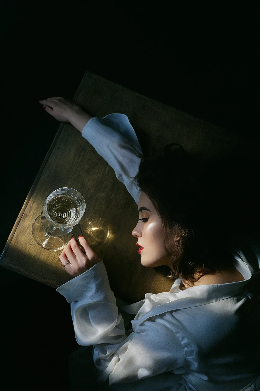 there is a woman laying on a table with a glass of wine, by Russell Drysdale, inspired by Vasily Perov, editorial photograph, inspired by Georges de La Tour, inspired by Artemisia Gentileschi, by Adam Chmielowski, in style of nan goldin, inspired by Nan Goldin, by Elsa Bleda