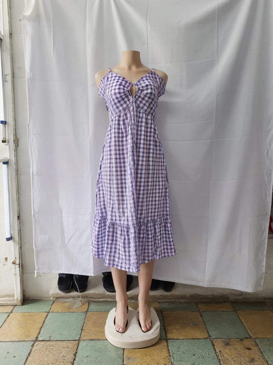 model, with purple and white checkered dress and white sandals