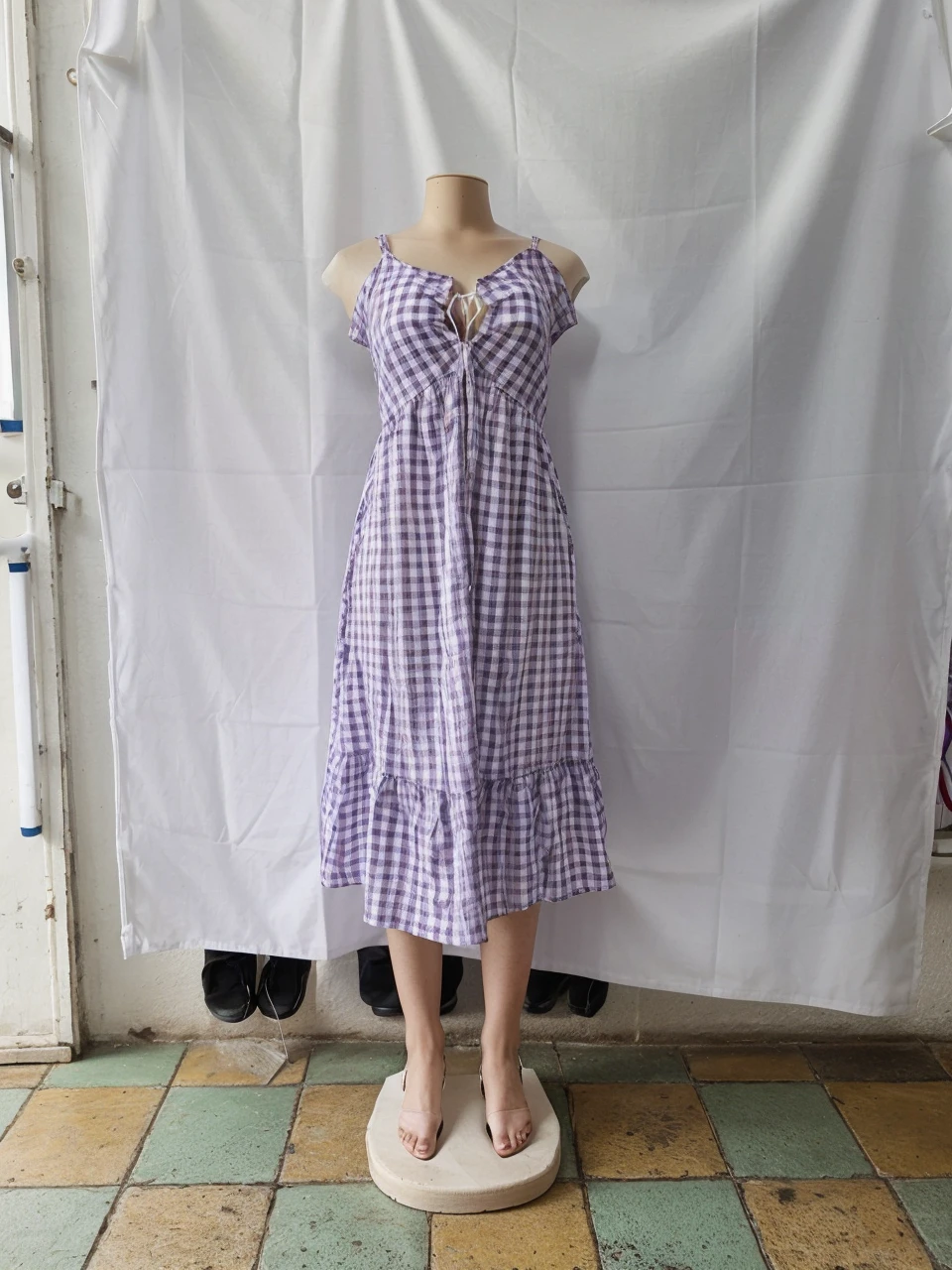 model, with purple and white checkered dress and white sandals