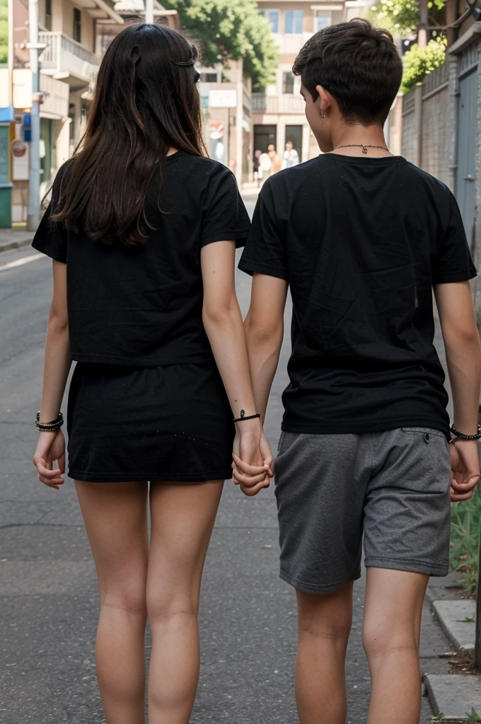 heterosexual couple of -yeld tes holding hands, a boy with a girl, both in black t-shirts, seen from behind and with black bracelets on their arms as they hold hands. both of the same height and with black t-shirts and tanned skin.