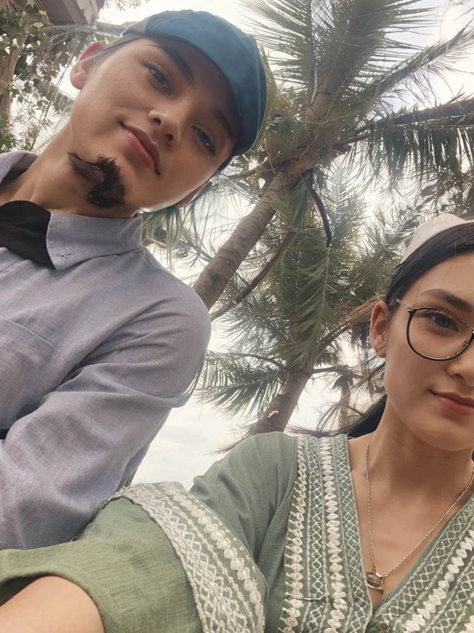 Girl with green hair and blue eyes With a kimono with a man Handsome with long black hair in grey shirt with cap The man is older than the girl