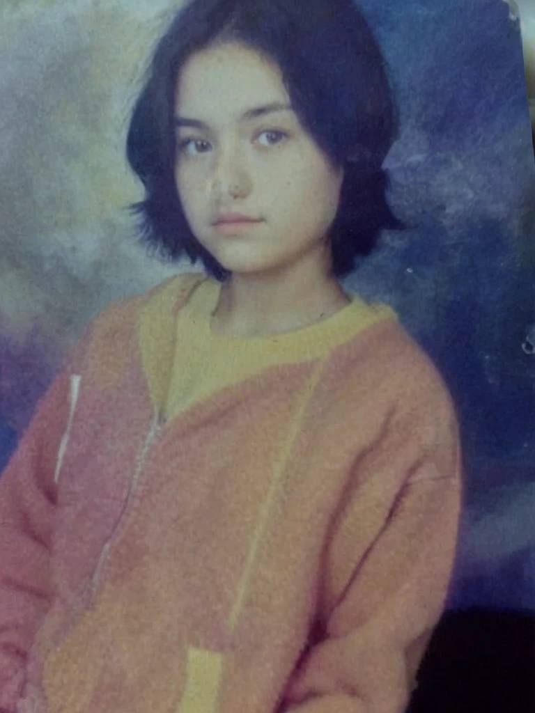 color photo of a 17 year old girl, short black hair. wearing an orange sweater jacket, white t-shirt. dark blue background photo studio. HD