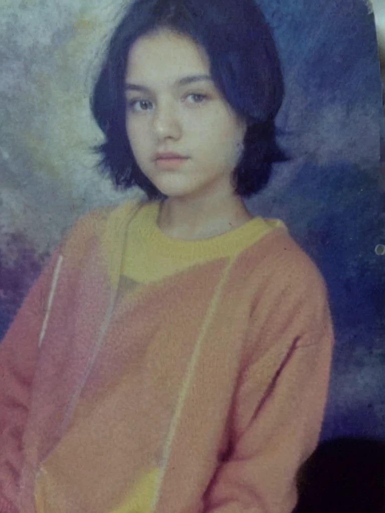 color photo of a 17 year old girl, short black hair. wearing an orange sweater jacket, white t-shirt. dark blue background photo studio. HD