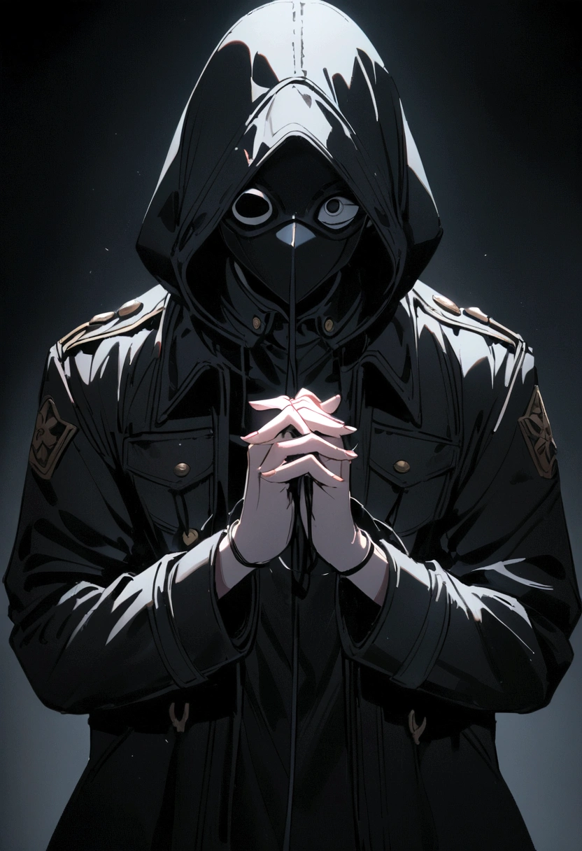 A person wearing a black mask with cut out eye and mouth holes stands against a dark background. This person is wearing a military jacket with a hoodie, his hands are tied together.