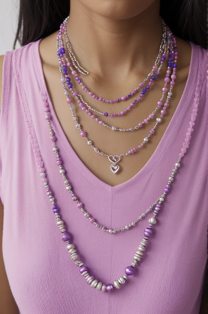 Multi-strand necklace with 3 rows, the first of which is made of pink beads, the second with purple beads and the third blue, thus simulating the colors of the bisexual flag and with a charm of an unfilled silver heart