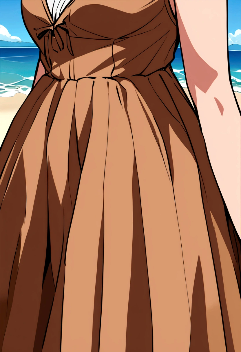 Colombian girl with the same face above dressed in brown dress who is on the beach