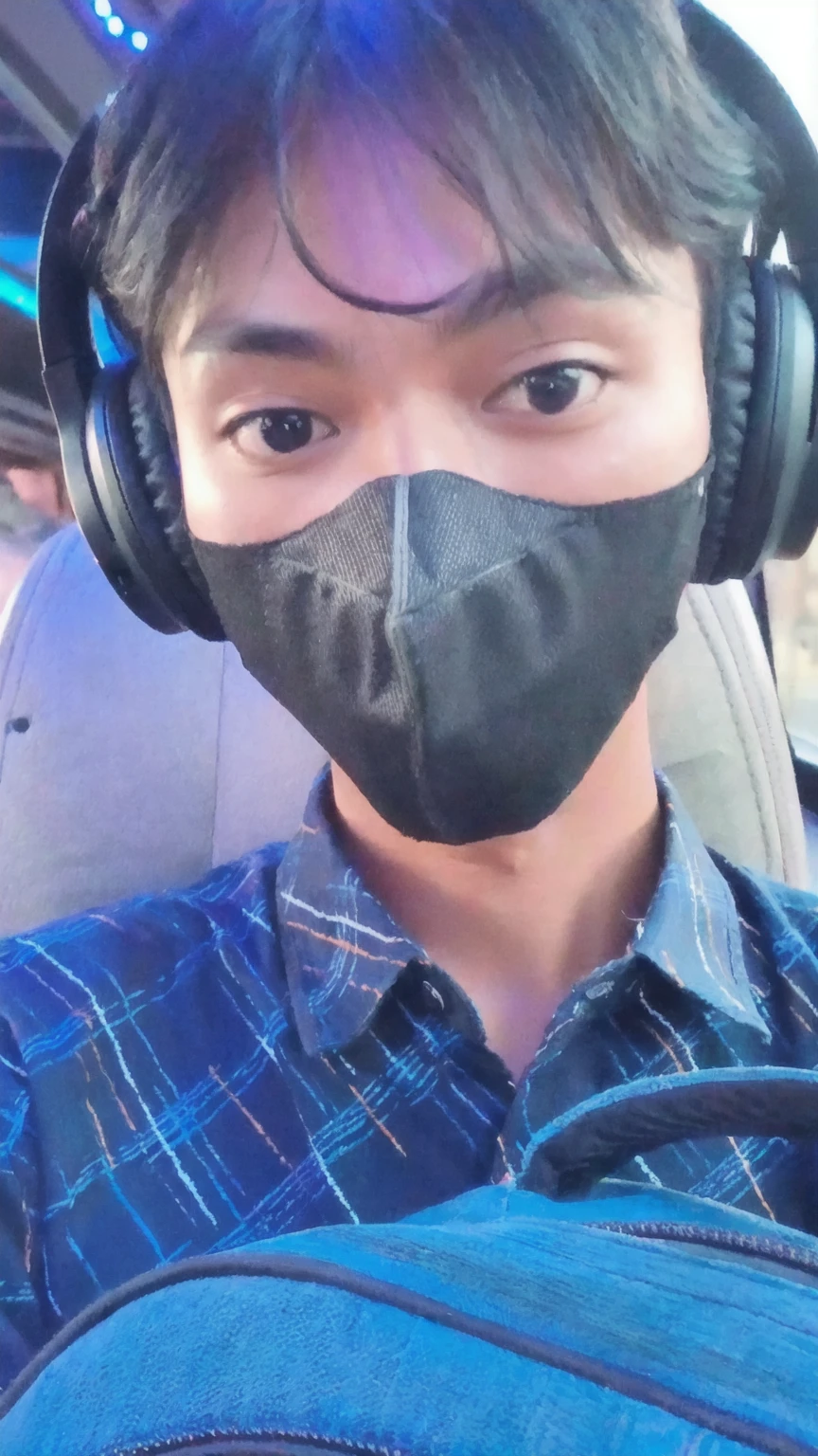 arafed man wearing a mask and headphones in a car, wearing all black mempo mask, wearing facemask, wearing mask, handsome man,