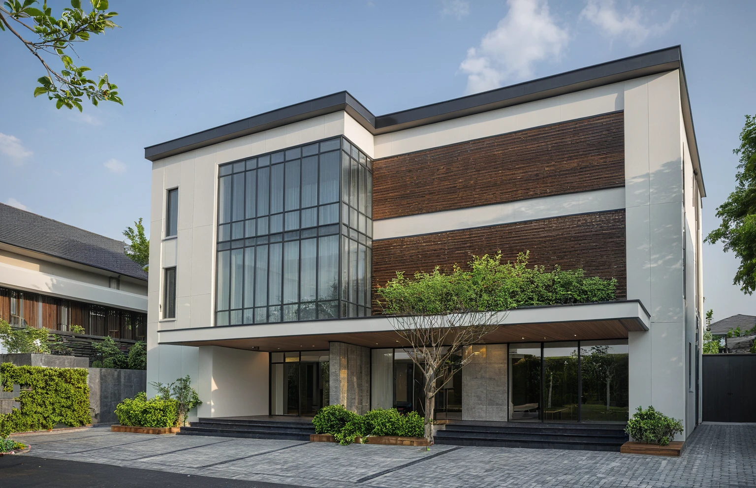 modern villa on street, (daylight), tropical tree, (slope roof, black tiled roof:1.2), vivid color, streetcapes, nice sky, grey tone, large glass door, warm interior lighting, modern material, best quality, ultra realistic, masterpiece, 17ArchiAI_XL_VL-v1