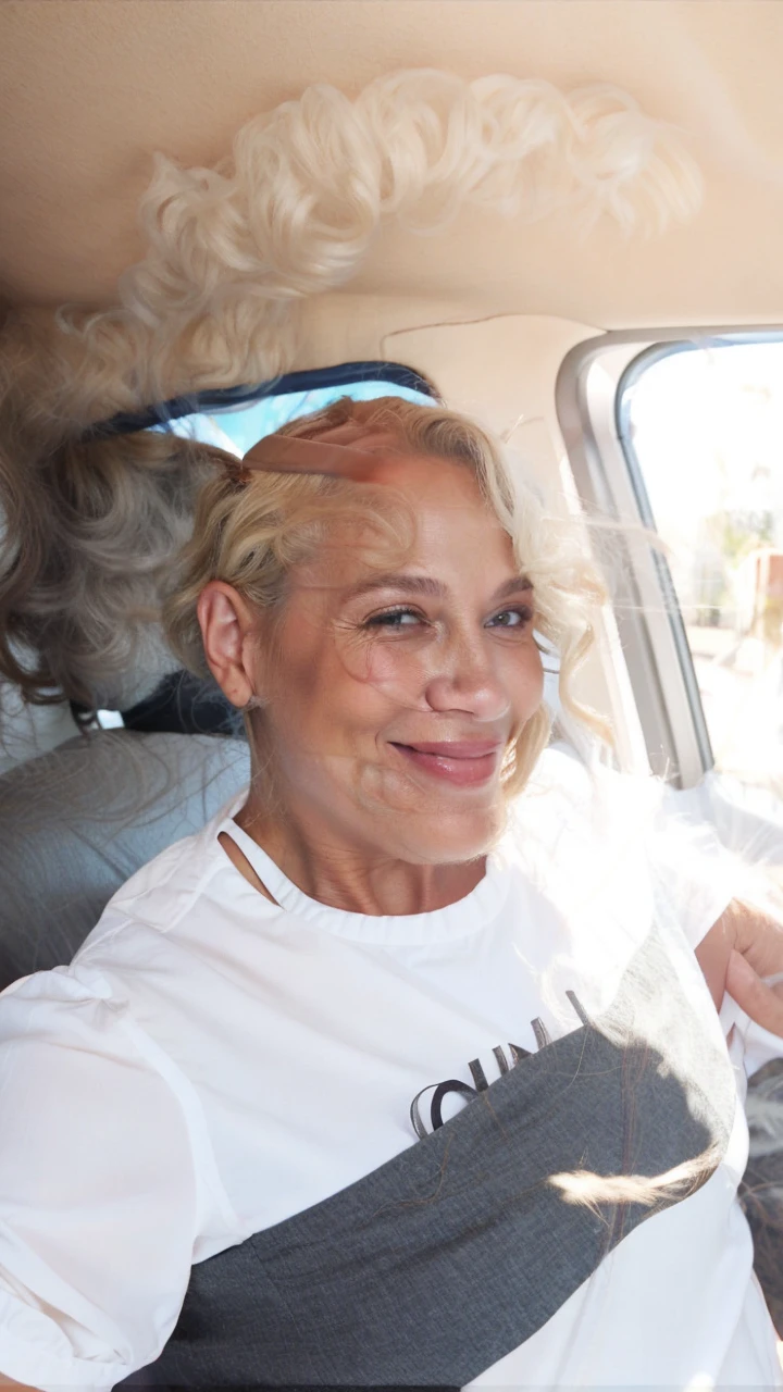 Woman 50 years old curly blonde hair brown eyes loving smile