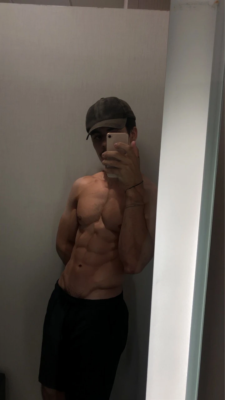 a 17 year old boy, short black hair, intense blue eyes, intense gaze, defined facial features, no facial hair, tall muscular build, broad shoulders, V-shaped body, wolf tattoo on right arm, full body focus, completely hairless, photorealistic, 8k, high quality, cinematic lighting, dramatic atmosphere, chiaroscuro lighting, moody color palette, dramatic rendering