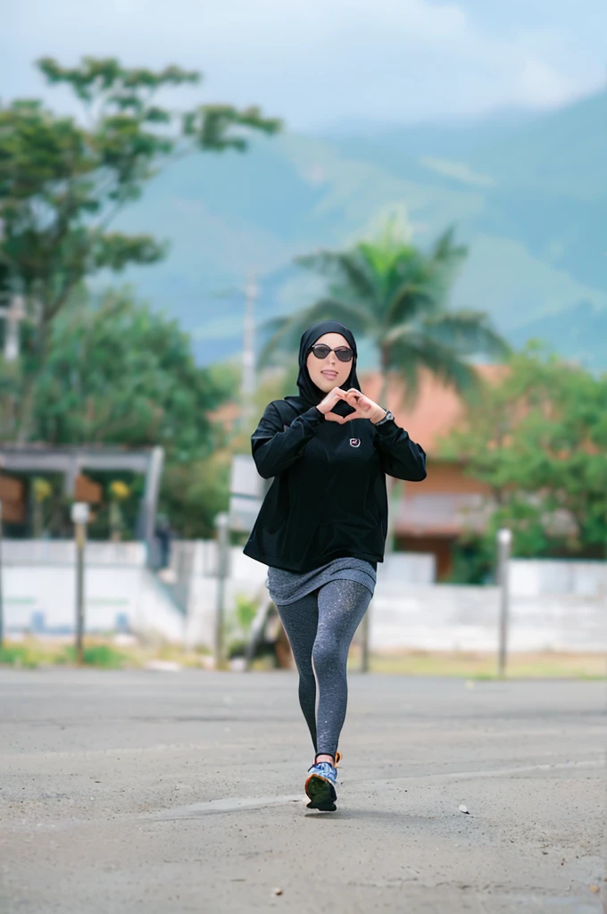 (Best quality,A high resolution,Ultra-detailed,Realistic:1.2),2023 skinny runner, woman wearing hijab, love hand pose(promotional poster)。