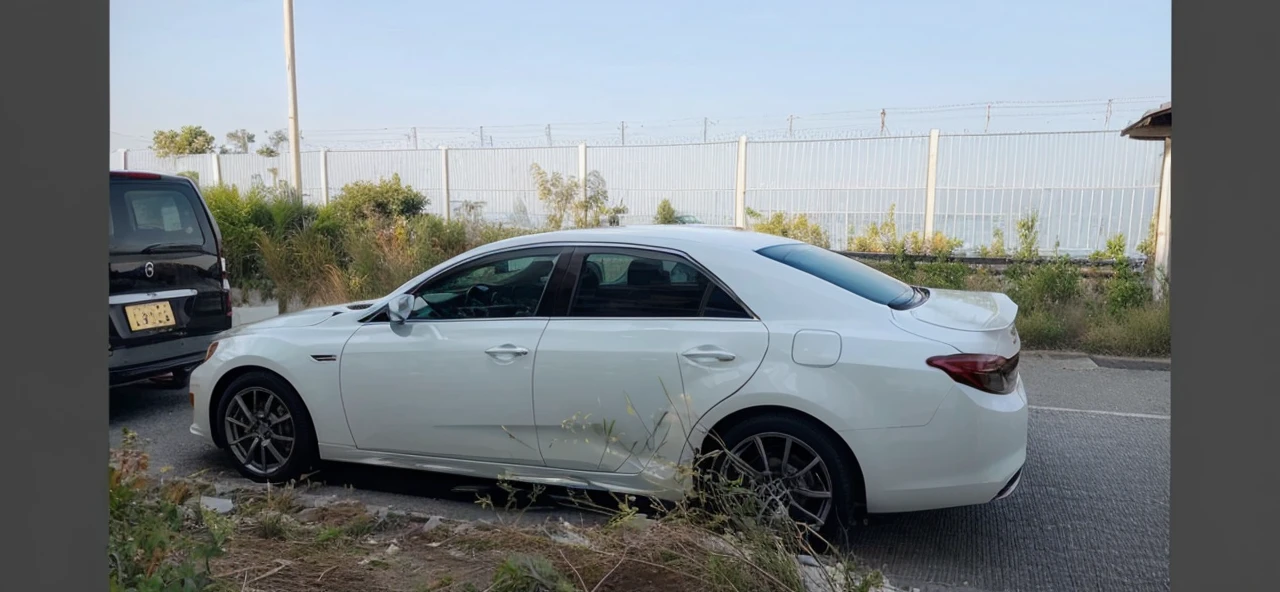 Change the background of the white private car to a beautiful sunset
