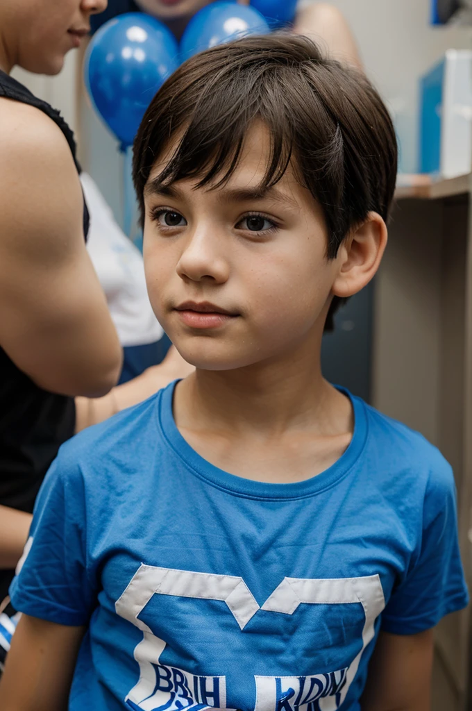 Boy wearing blue and white t-shirt is at a birthday party